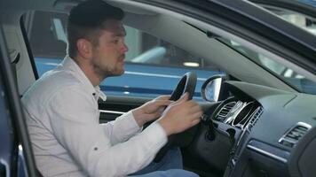 Man examines car interior at the dealership video