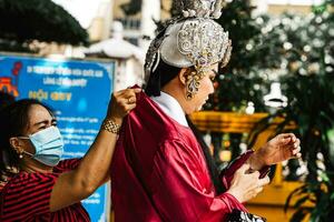 Ho Chi Minh City, Vietnam - August 19, 2023 Artists performing Vietnamese classical opera make up for the show in Binh Thanh District photo