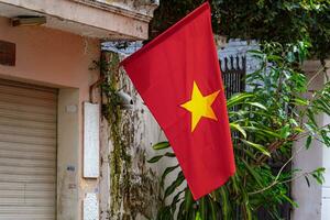 Ho Chi Minh City, Vietnam - 29 August, 2023Flat small alley street of Vietnam in Independence Day with two side of flag hang to houses photo