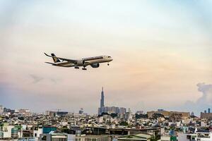 Ho Chi Minh, Vietnam - 7 August 2023 Airlines fly past landmark 81, the tallest building in Vietnam, to land at Tan Son Nhat international airport. photo