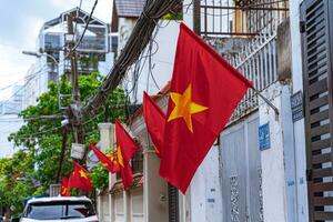 Ho Chi Minh City, Vietnam - 29 August, 2023Flat small alley street of Vietnam in Independence Day with two side of flag hang to houses photo