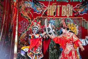 Ho Chi Minh City, Vietnam - August 19, 2023 Artists performing Vietnamese classical opera as know as Hat Boi in Binh Thanh District photo