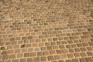 The road is paved with stones as a background. photo