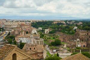 View of roofs of Rome under cloudy sky. photo