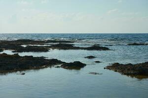 The stone coast of the Mediterranean Sea in Cyprus. photo