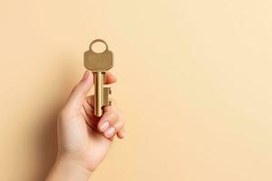 Hand holding key, isolated on beige . AI Generated photo