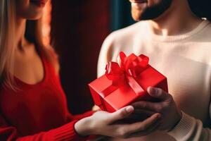 Close up shot of female hands holding a small gift wrapped with red ribbon. AI Generated photo