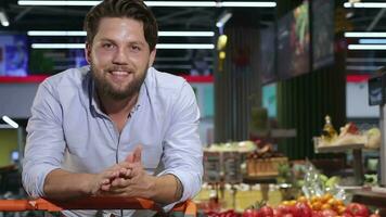 Man poses with trolley at the hypermarket video