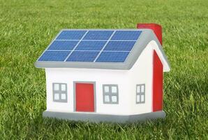 House model plastic with solar panels photo