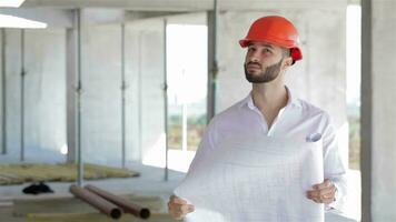 Architector looks at the plan of the building under construction video