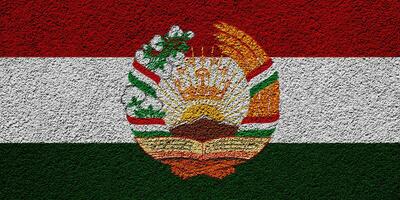 bandera y Saco de brazos de república de Tayikistán en un texturizado antecedentes. concepto collage. foto
