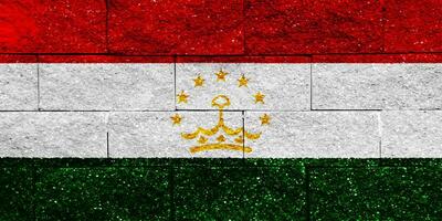 Flag of Republic of Tajikistan on a textured background. Concept collage. photo