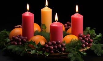 dark background with candles and holly greenery photo