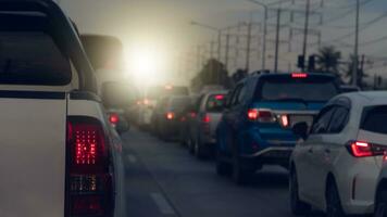 Rear side of pickup car white color with turn on brake light on asphalt roads. During rush hours for travel or business work. Environment of traffic jam with many cars. photo