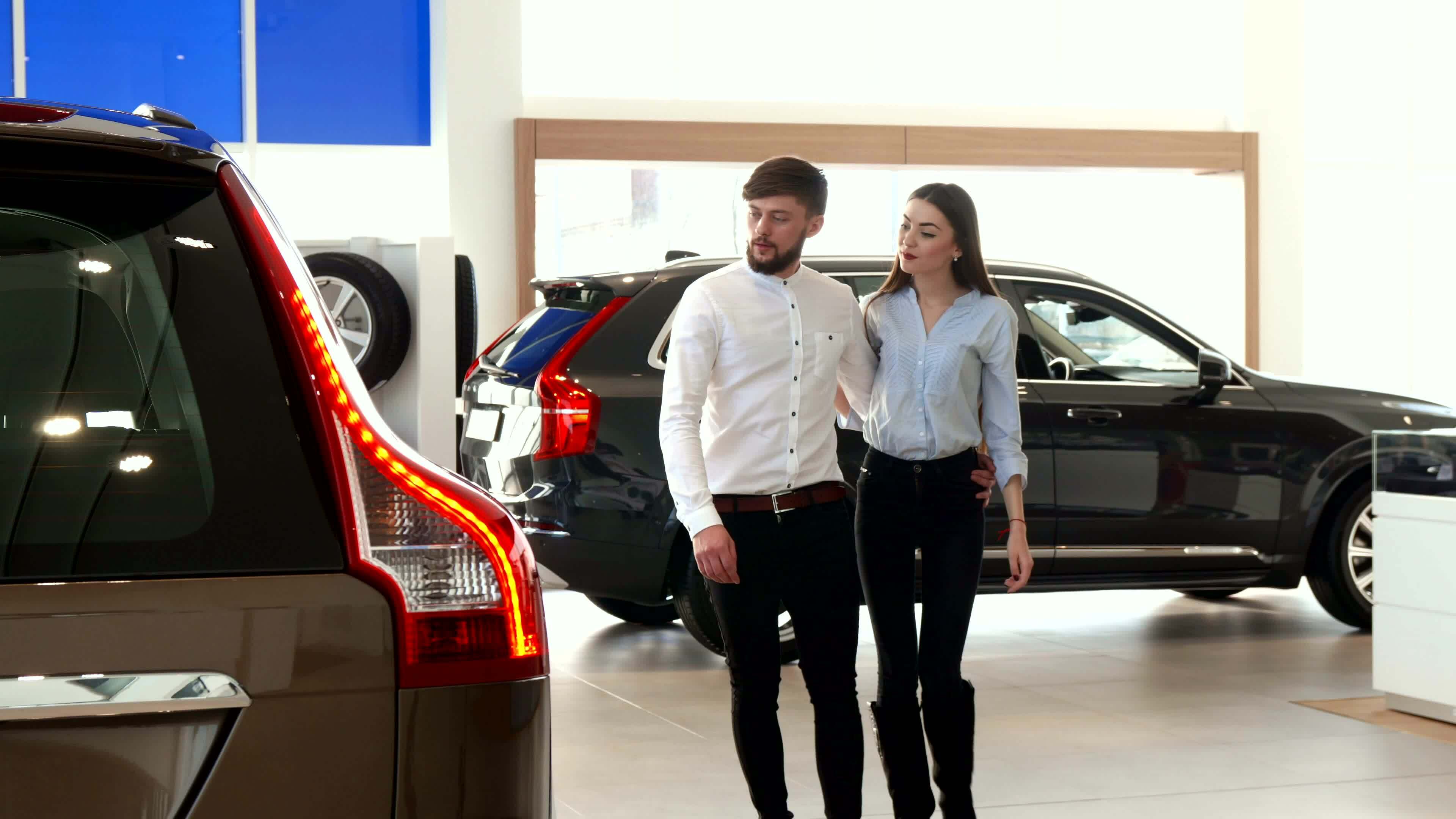 Couple walks at the car dealership 33532308 Stock Video at Vecteezy
