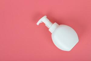 Cosmetic mock up bottle on pastel pink background photo