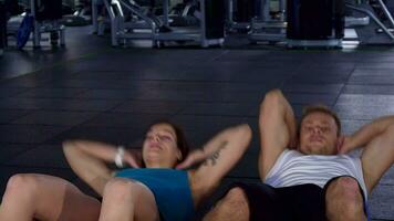 Fitness man and woman train their abdominal muscles video