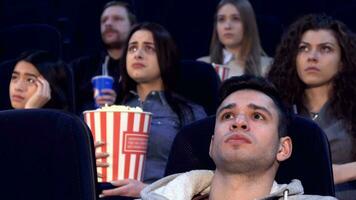 People watch serious film at the movie theater video