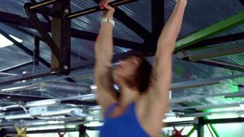 Woman does kipping pull ups video