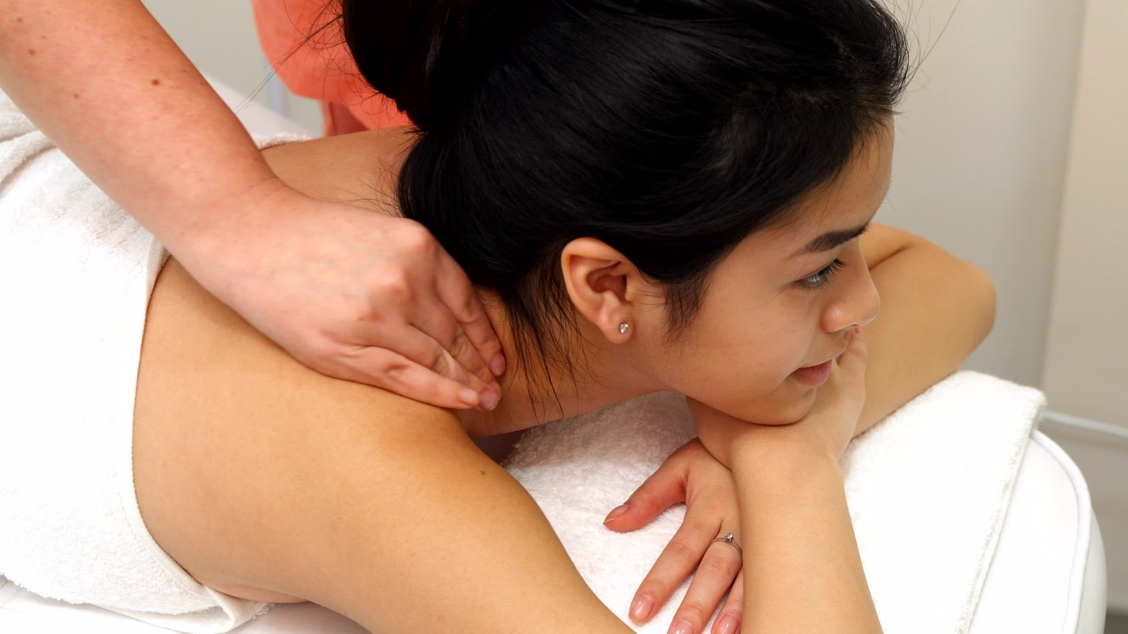 Shoulder and neck massage for woman in spa salon. Stock Photo by