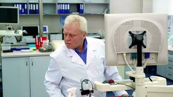 Male scientist looks to the side at the laboratory video