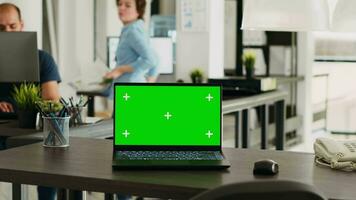 Urban coworking space desk with greenscreen design and copyspace on display at empty seat. Chromakey screen technology is used by smaller enterprises, isolated mockup layout on laptop. video