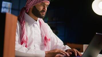 Man in living room paying attention in elearning seminar, writing memo to remember later. Homeschooling student listening to lesson while taking note of weekend homework, close up video