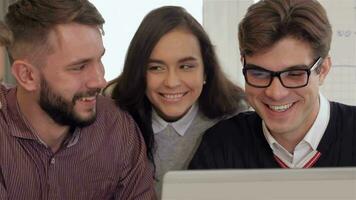 Members of creative team smile to each other at the office video