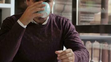 Man enjoys the aroma of the coffee at the cafe video