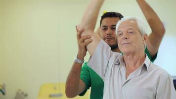 Senior man lifts up the dumbbell at the hospital video