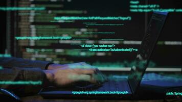 Programmer's hands and laptop keyboard close-up. The developer writes the application code video