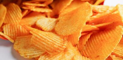 Potato chips in open bag, delicious BBQ seasoning spicy for crips, thin slice deep fried snack fast food. photo