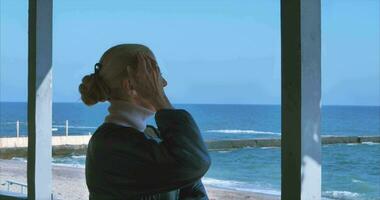 A girl on the shore of the Black Sea breathes sea air during the day video