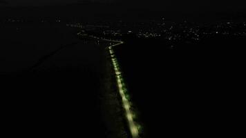 aerial view of a deserted street at night. aerial view of a row of street lights on the edge of Lake Limboto, Gorontalo-Indonesia video