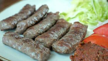 Kebab, traditional turkish meat food with salad on a plate . video