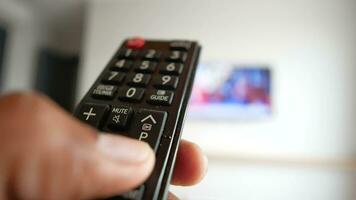 close up of man hand holding tv remote. video