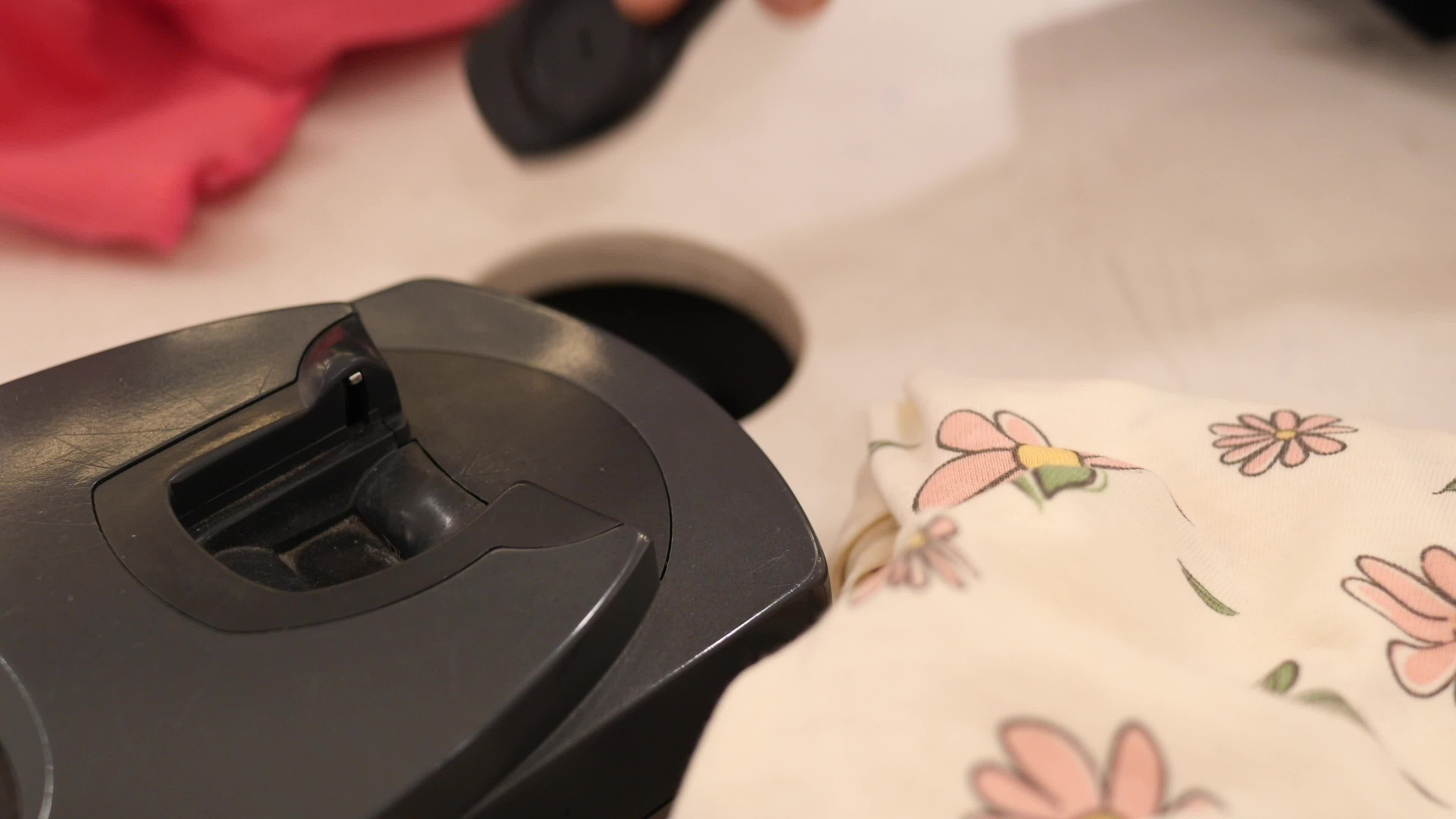 removing Clothing security tag on a shirt , 33539366 Stock Video at