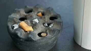 Close up burning cigarette in ashtray on table video