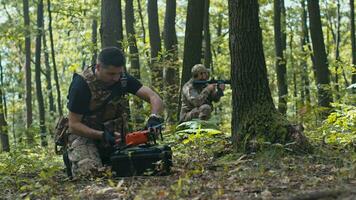 A Soldier Setting Up the Drone for Flight While His Comrade Guards Him video