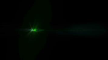 Burst glow green star light optical lens flares shine art animation movint from left to right side on black abstract background video