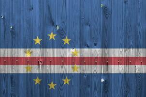 Cabo verde flag depicted in bright paint colors on old wooden wall. Textured banner on rough background photo