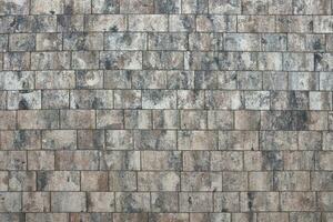 Marble tiles on brick floor or wall background with grey and brown colors front or top view photo