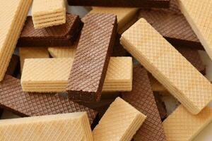 Stacked delicious chocolate wafers in large amount. Two different flavours of classic waffles photo