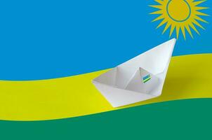 Rwanda flag depicted on paper origami ship closeup. Handmade arts concept photo