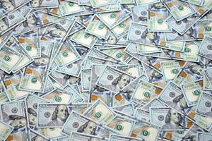 Very big amount of US hundred dollar bills. Huge quantity of united states currency notes on flat table photo