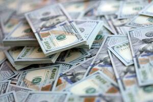 Very big amount of US hundred dollar bills. Huge quantity of united states currency notes on flat table photo