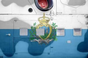 San Marino flag depicted on side part of military armored helicopter closeup. Army forces aircraft conceptual background photo