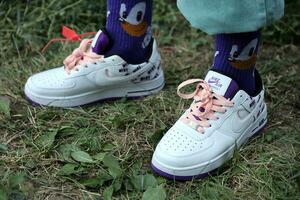 KYIV, UKRAINE - JULY 7, 2023 Fashion Sneakers Nike Air Force 1 on grass photo