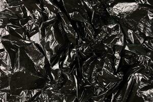 Texture of black plastic garbage disposable bag photo