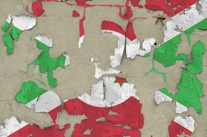 Burundi flag depicted in paint colors on old obsolete messy concrete wall closeup. Textured banner on rough background photo